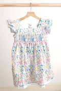 Floral Easter bunny hand-smocked dress with pastel colors and puffed sleeves.