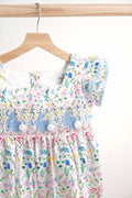 Floral Easter bunny hand-smocked dress with pastel colors and puffed sleeves.