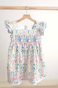 Floral Easter bunny hand-smocked dress with pastel colors and puffed sleeves.