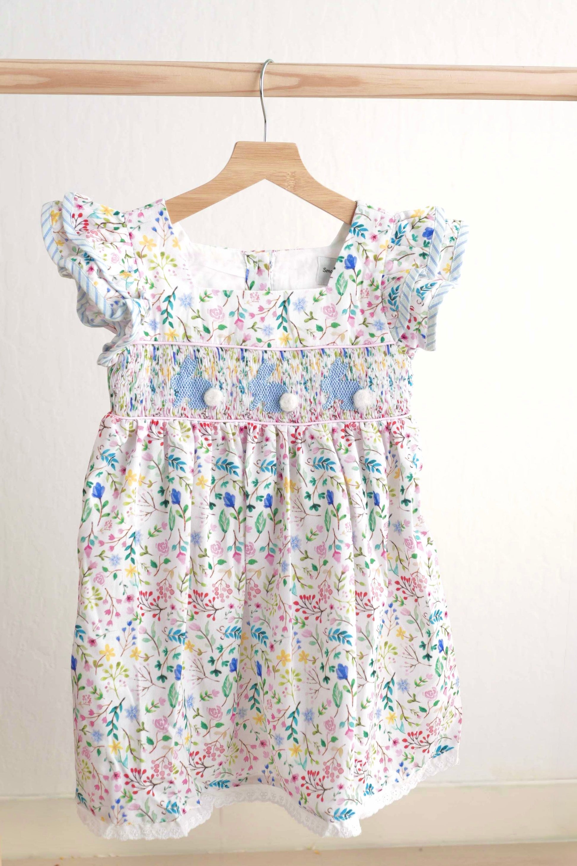Floral Easter bunny hand-smocked dress with pastel colors and puffed sleeves.