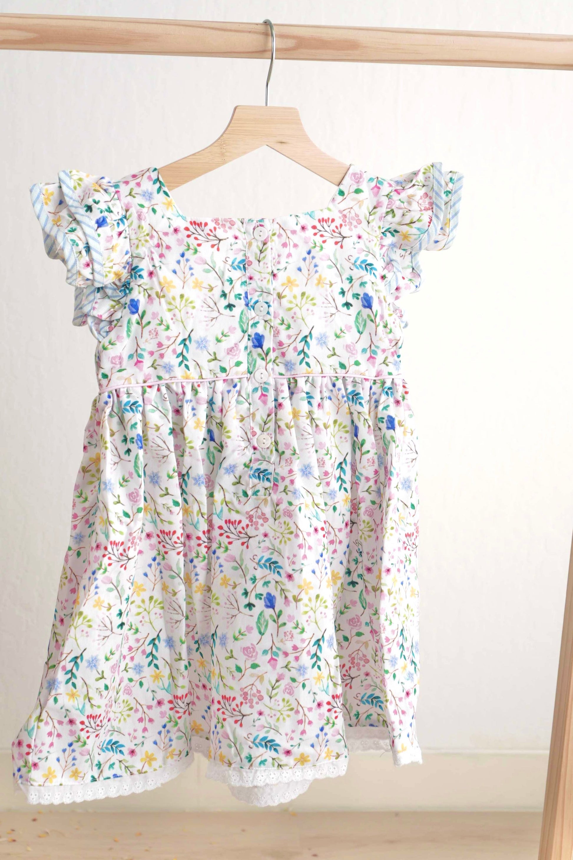 Floral Easter bunny hand-smocked dress with pastel colors and puffed sleeves.