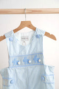 Blue Easter bunny hand-smocked jonjon with playful bunny pattern for boys.