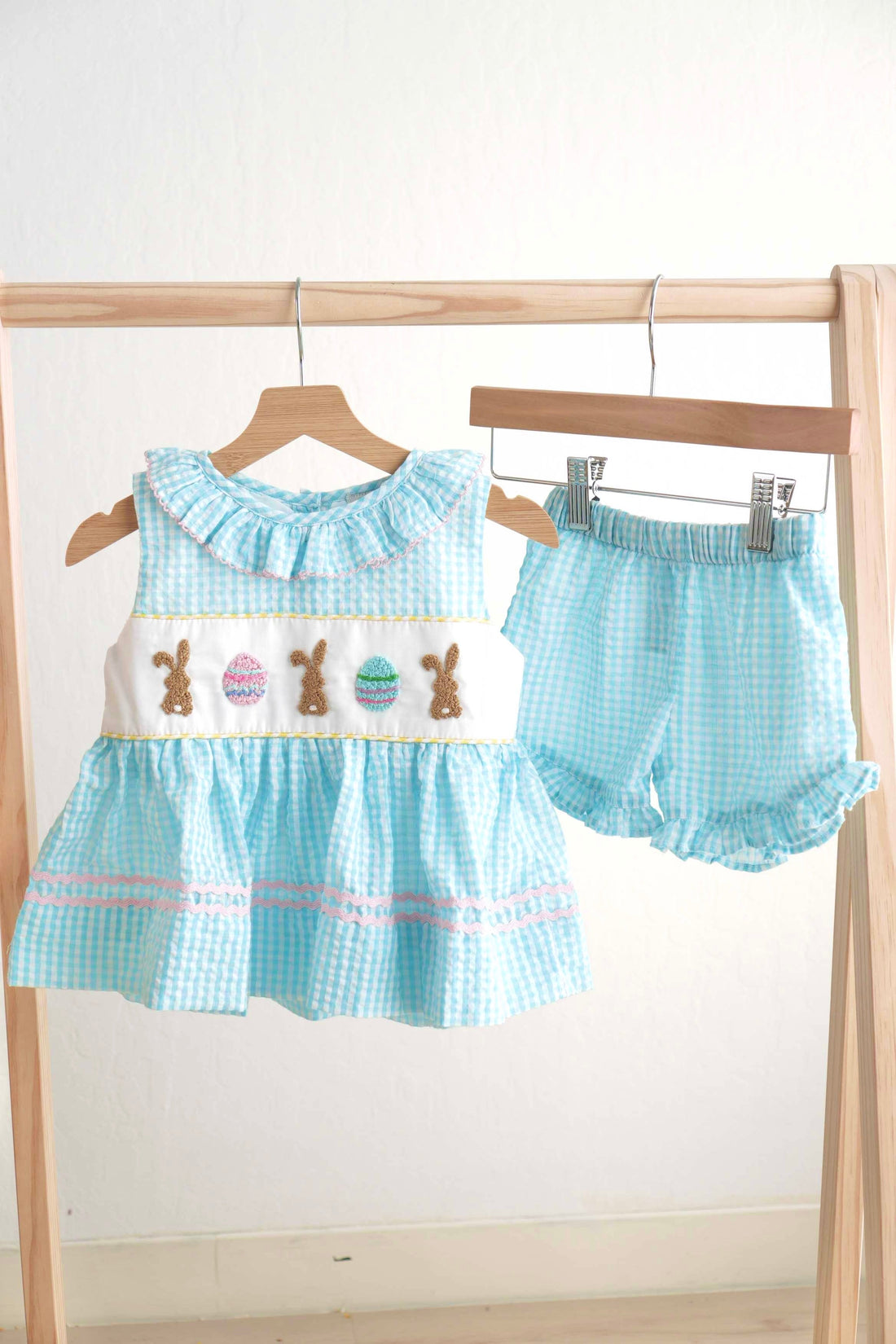 Blue gingham seersucker set with Easter bunny and egg embroidery, perfect for spring.