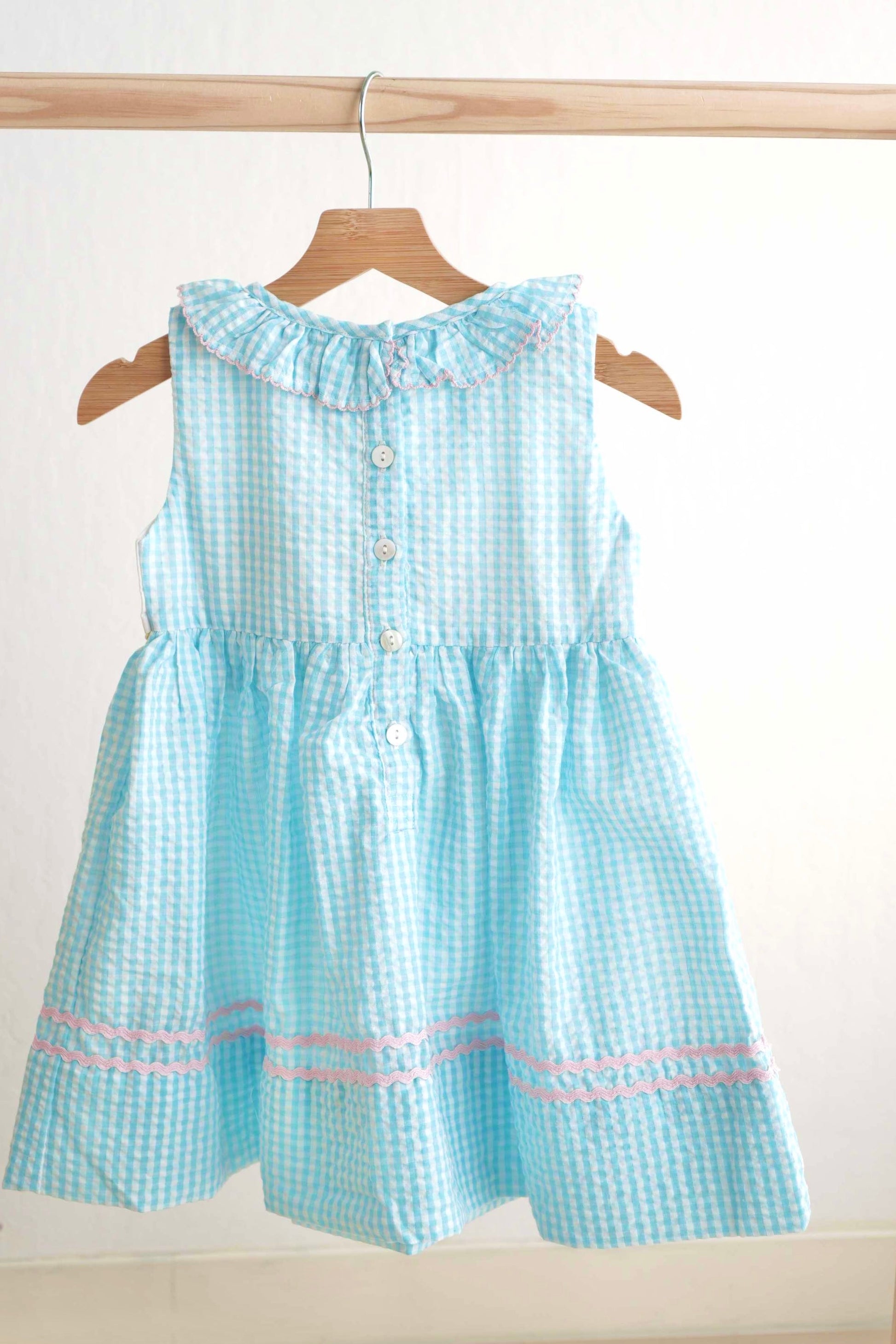 Blue gingham seersucker dress with Easter bunny and egg French knot design.
