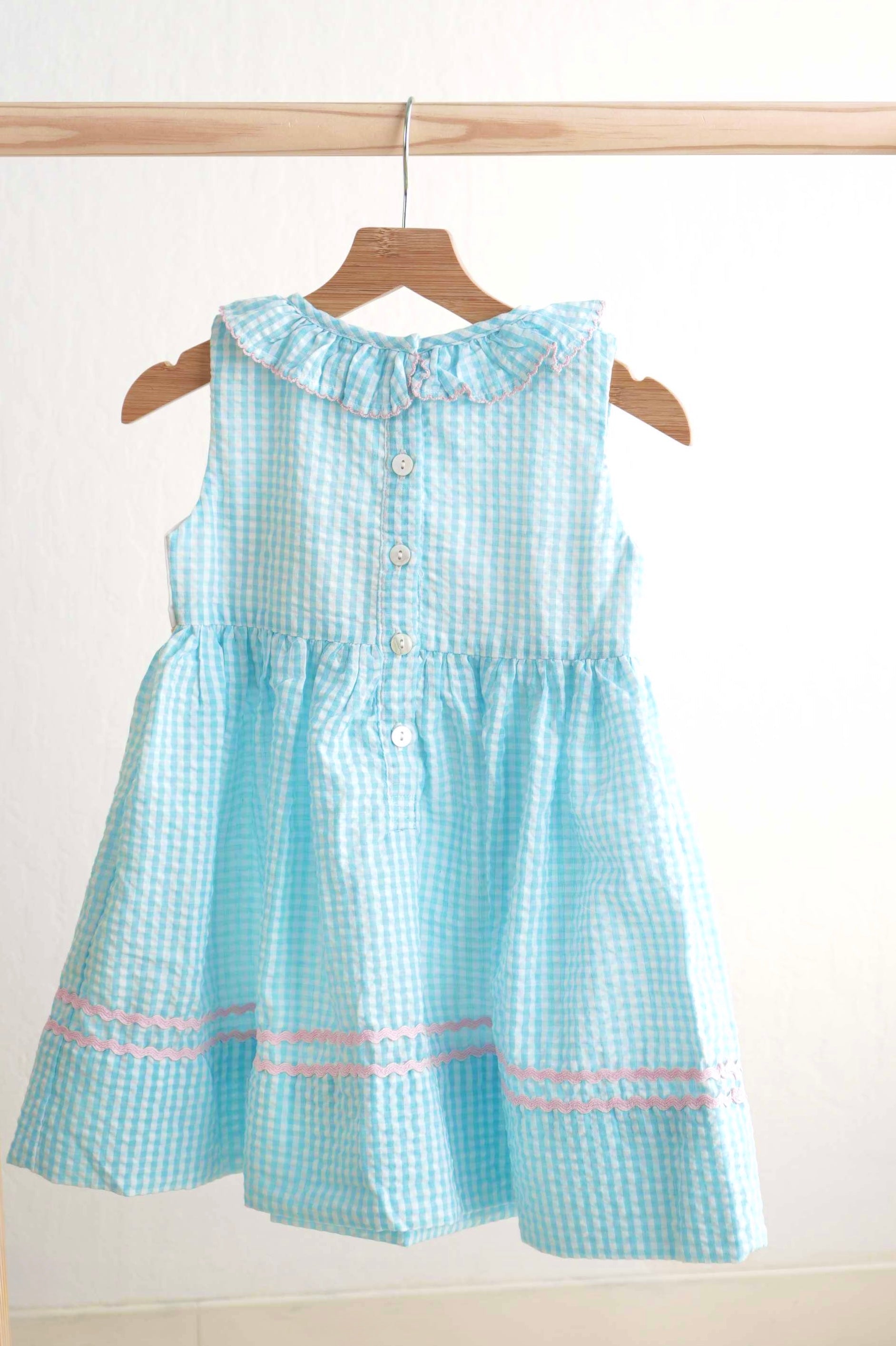 Blue gingham seersucker dress with Easter bunny and egg French knot design.