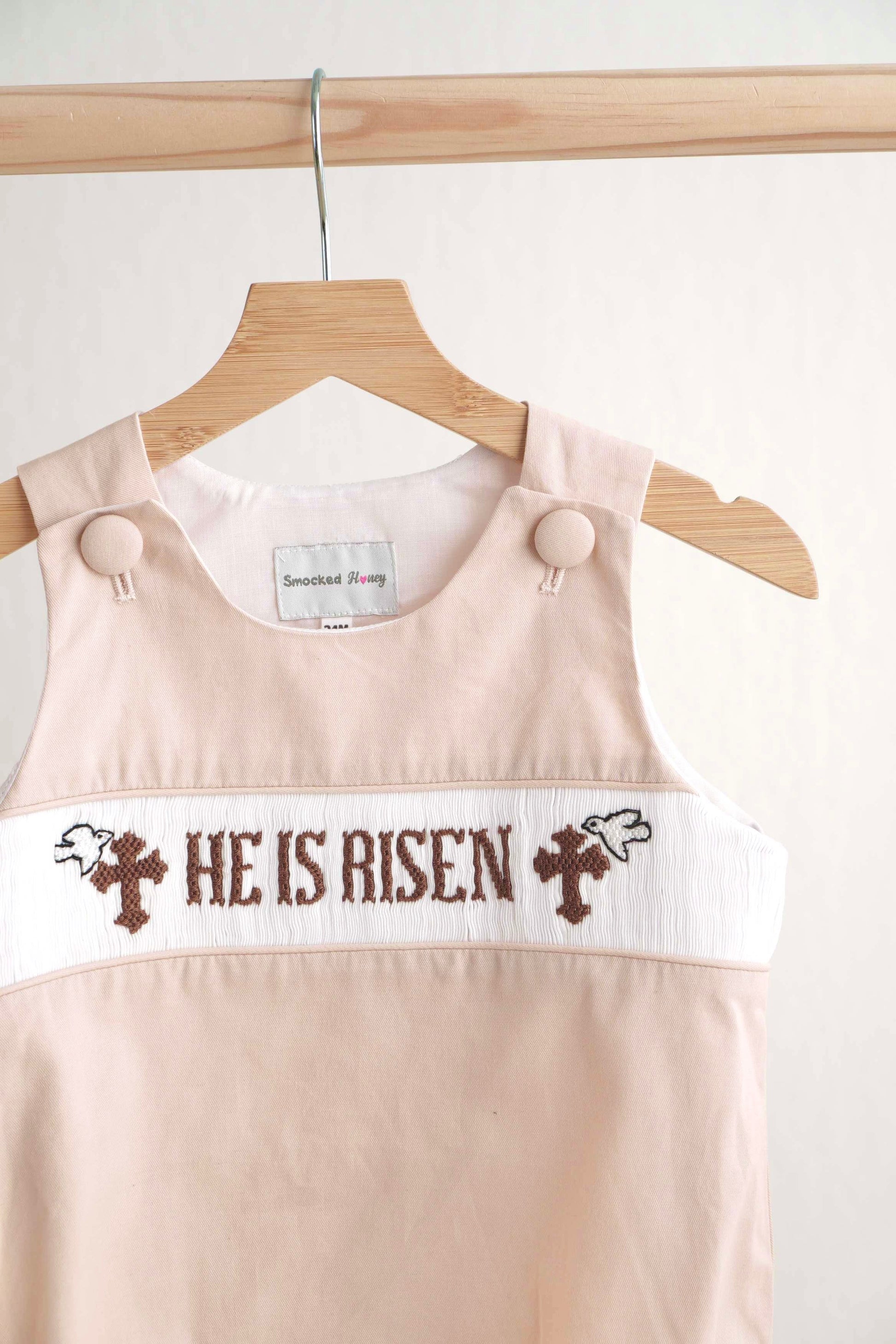 Khaki hand-smocked boy bubble with "He is Risen" Easter embroidery.