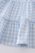 A charming blue tiered dress with playful farm-themed embroidery, perfect for kids.