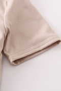 Khaki long-sleeve top with colorful truck applique, perfect for playful adventures.