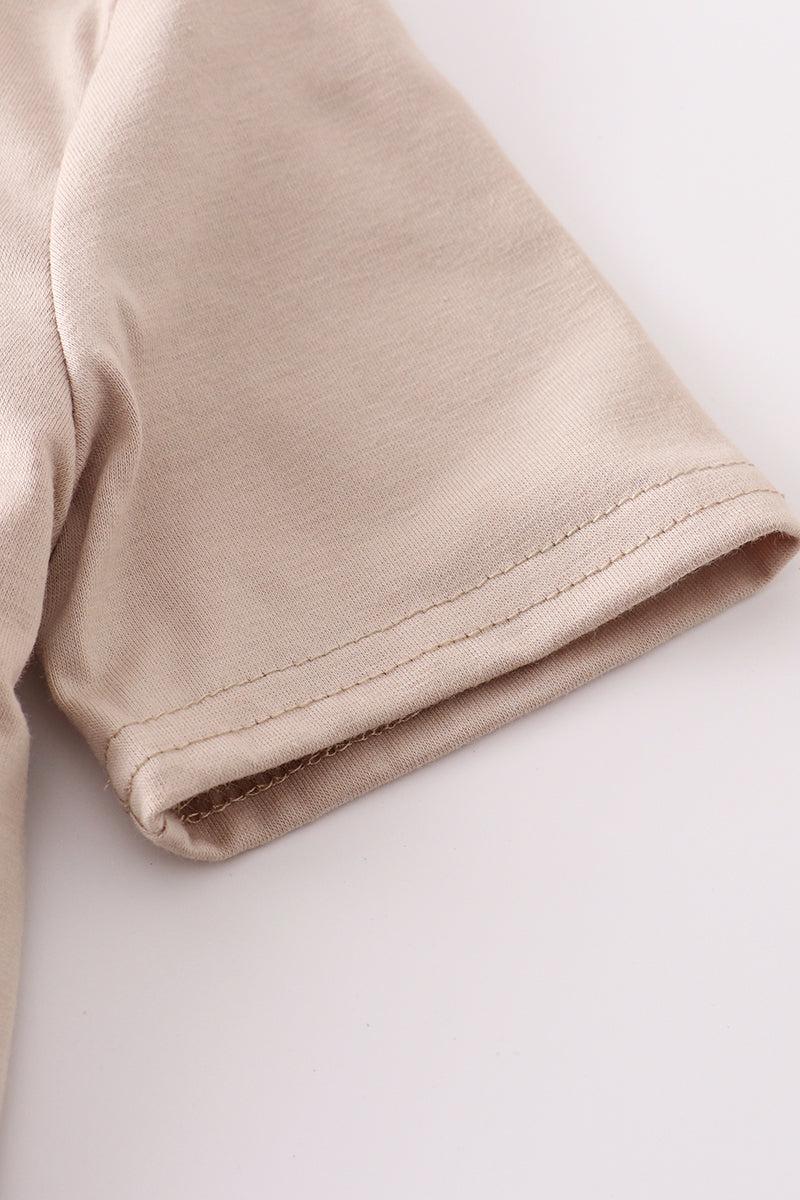 Khaki long-sleeve top with colorful truck applique, perfect for playful adventures.