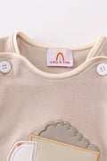 Khaki bubble romper with a cheerful truck applique, perfect for playtime.