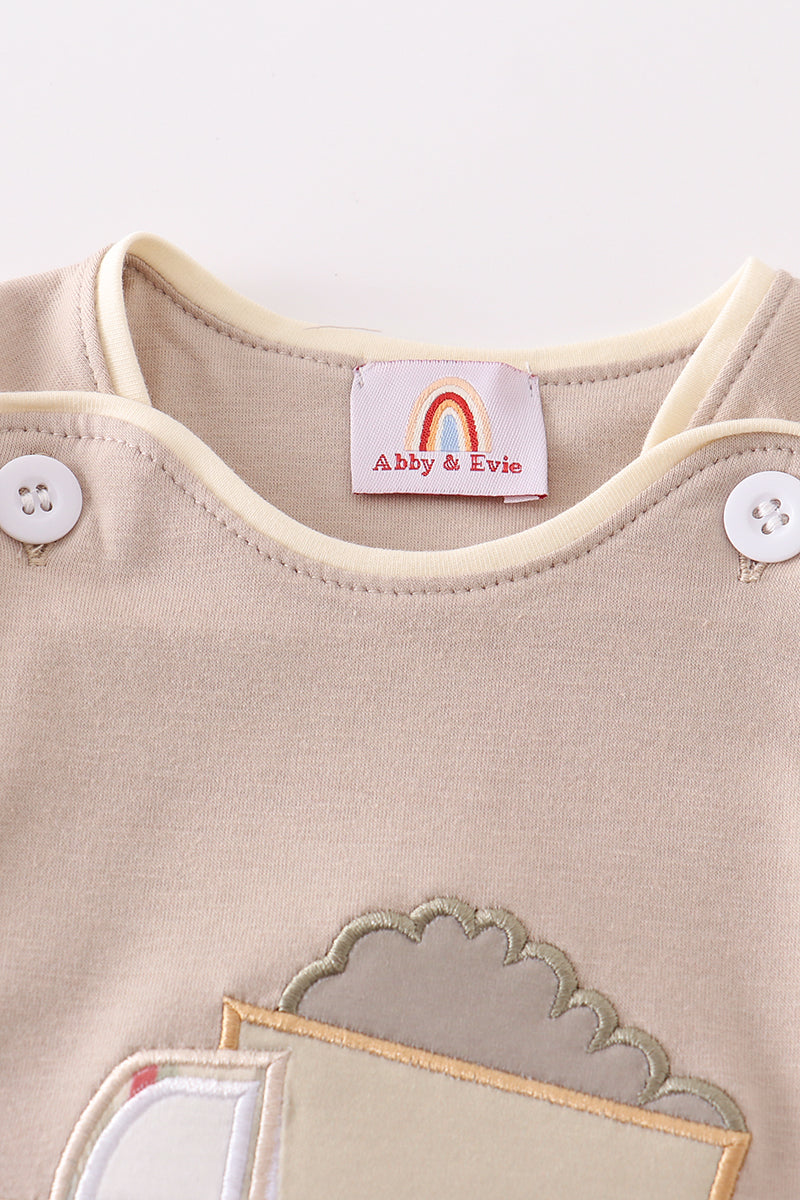 Khaki bubble romper with a cheerful truck applique, perfect for playtime.