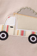 Khaki bubble romper with a cheerful truck applique, perfect for playtime.