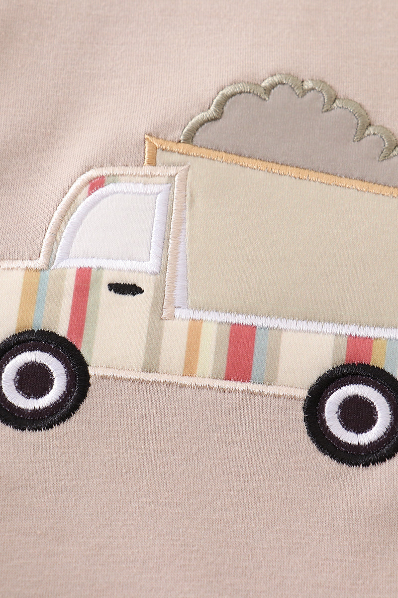 Khaki bubble romper with a cheerful truck applique, perfect for playtime.