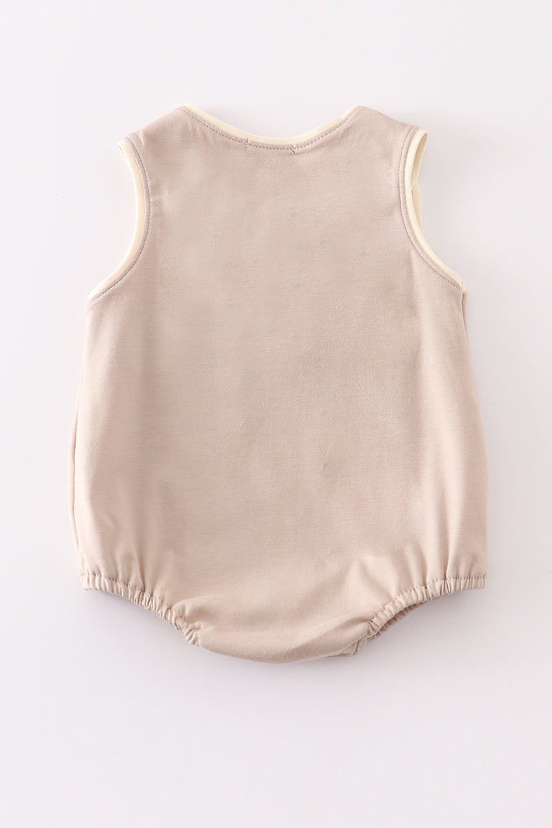 Khaki bubble romper with a cheerful truck applique, perfect for playtime.