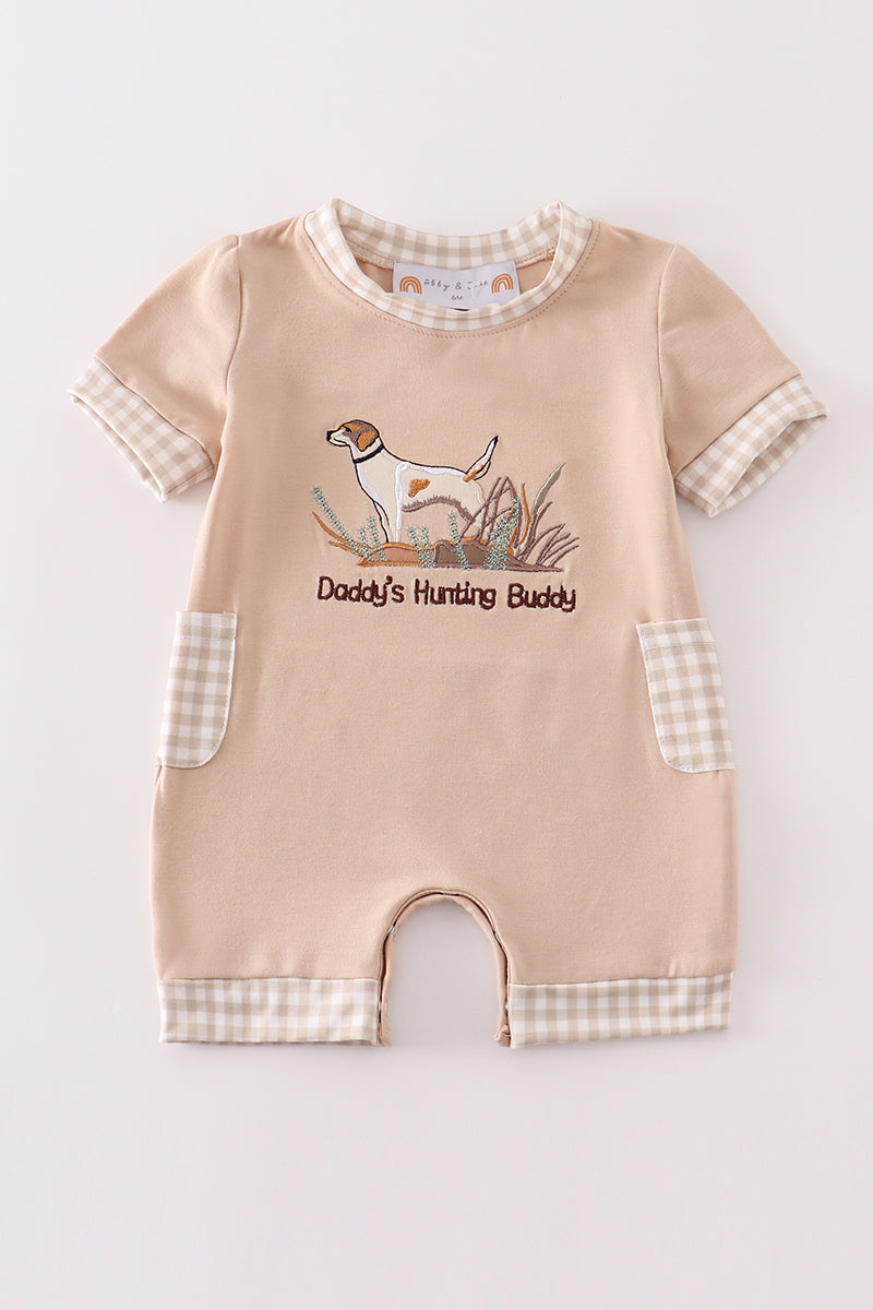 A cozy, blue romper with "Daddy's Hunting Buddy" embroidered in playful font.