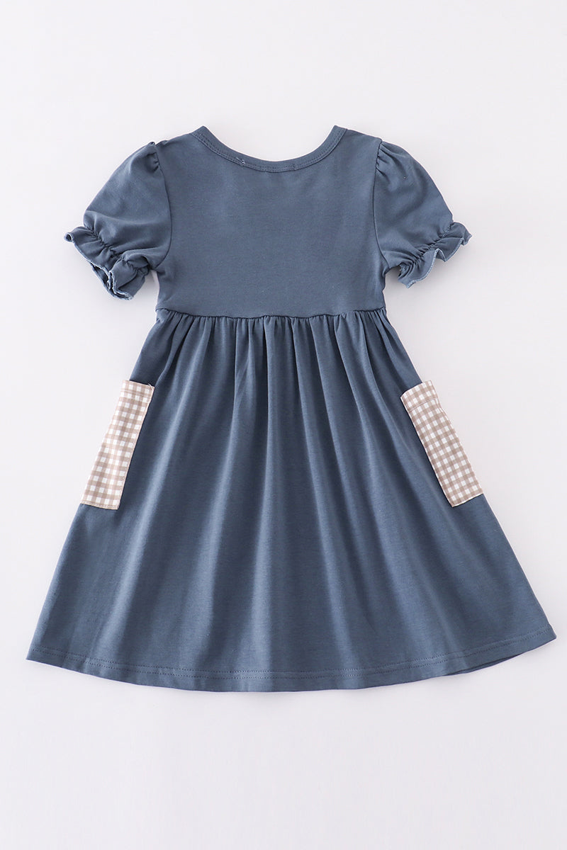Navy dress with playful hunting embroidery, perfect for adventurous little ones.