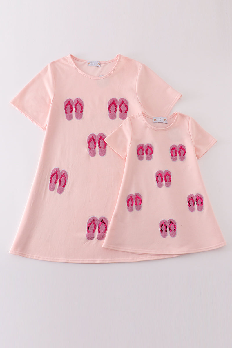 Matching pink sequin dresses with slippers, perfect for mom and daughter twinning.