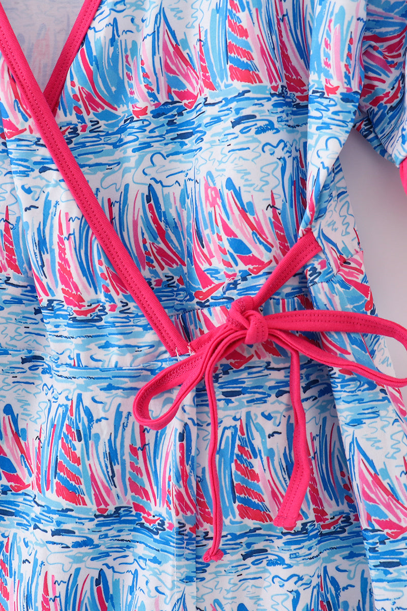 Matching mom and me dresses with playful blue sailboat print, perfect for summer outings.