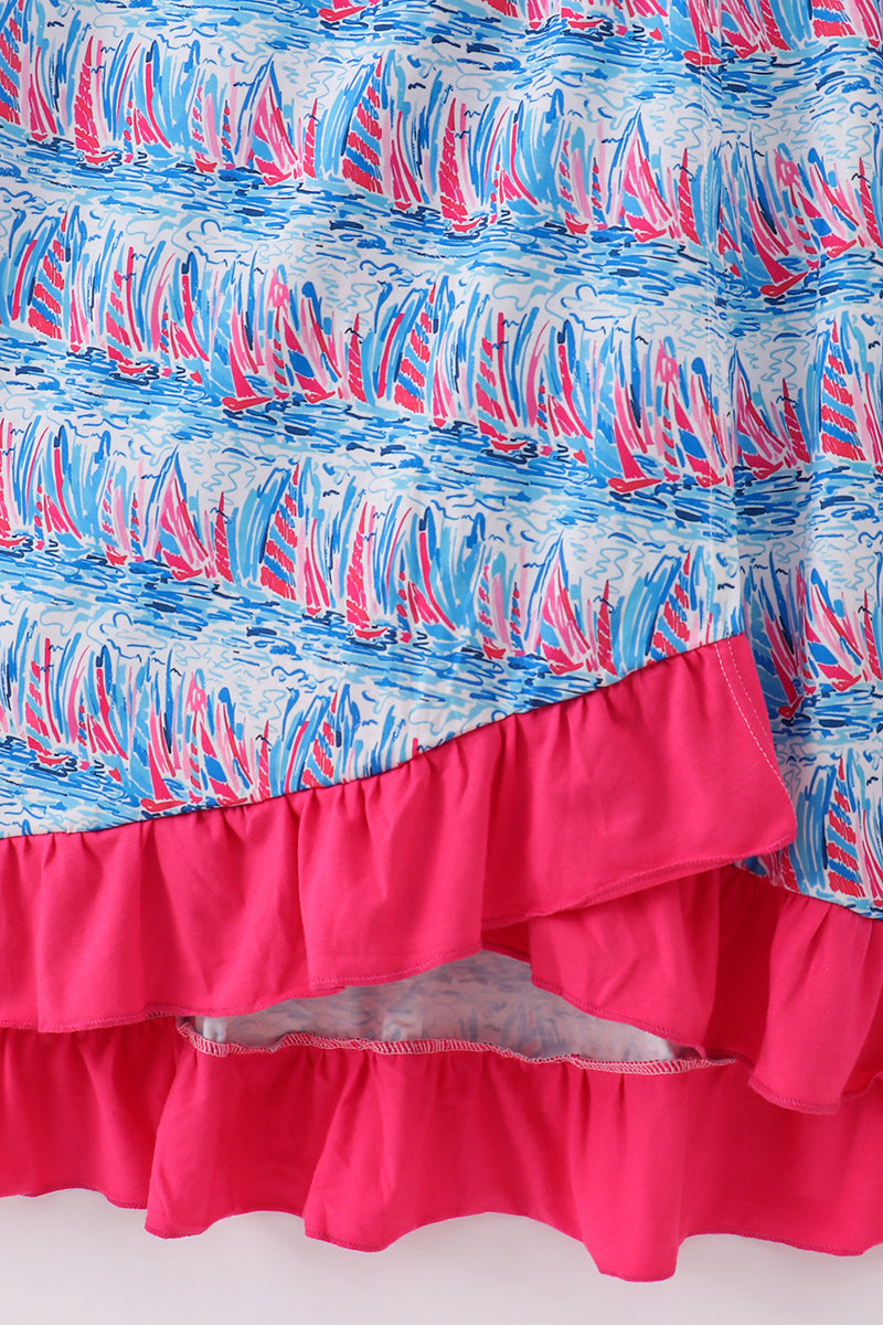 Matching mom and me dresses with playful blue sailboat print, perfect for summer outings.