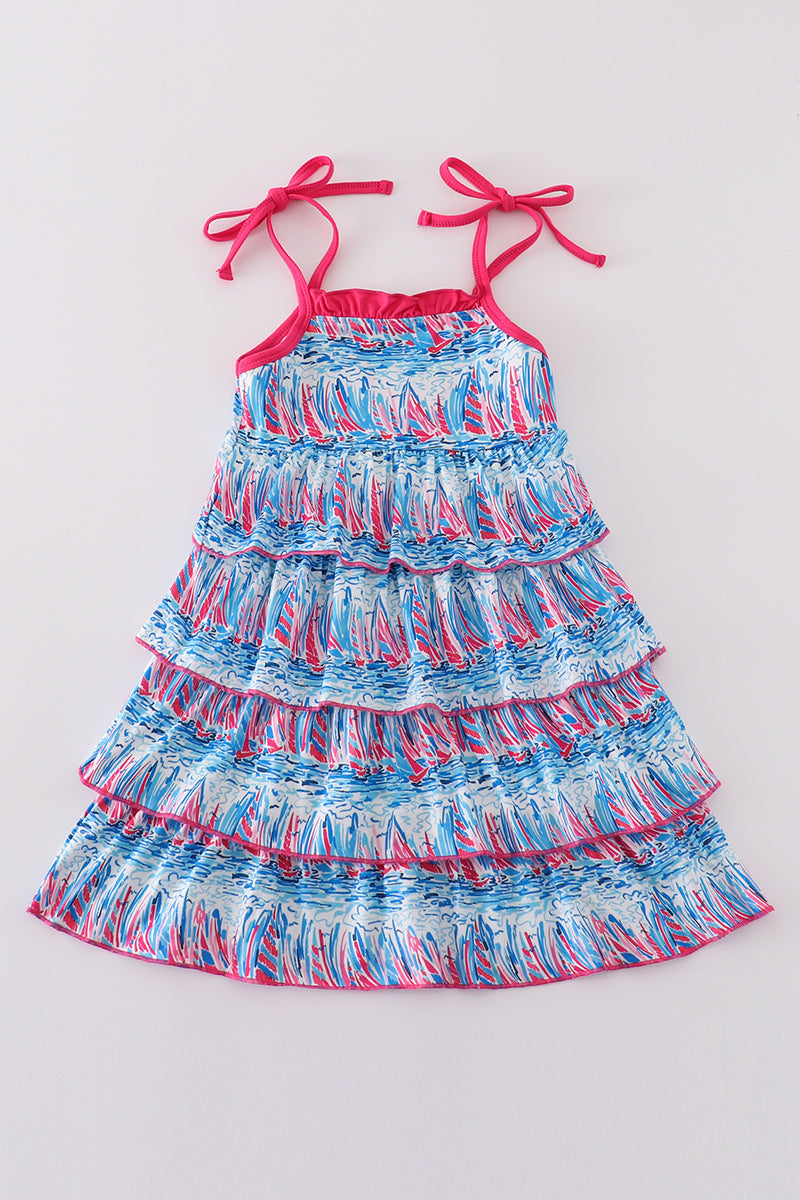 Matching mom and me dresses with playful blue sailboat print, perfect for summer outings.