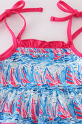 Matching mom and me dresses with playful blue sailboat print, perfect for summer outings.