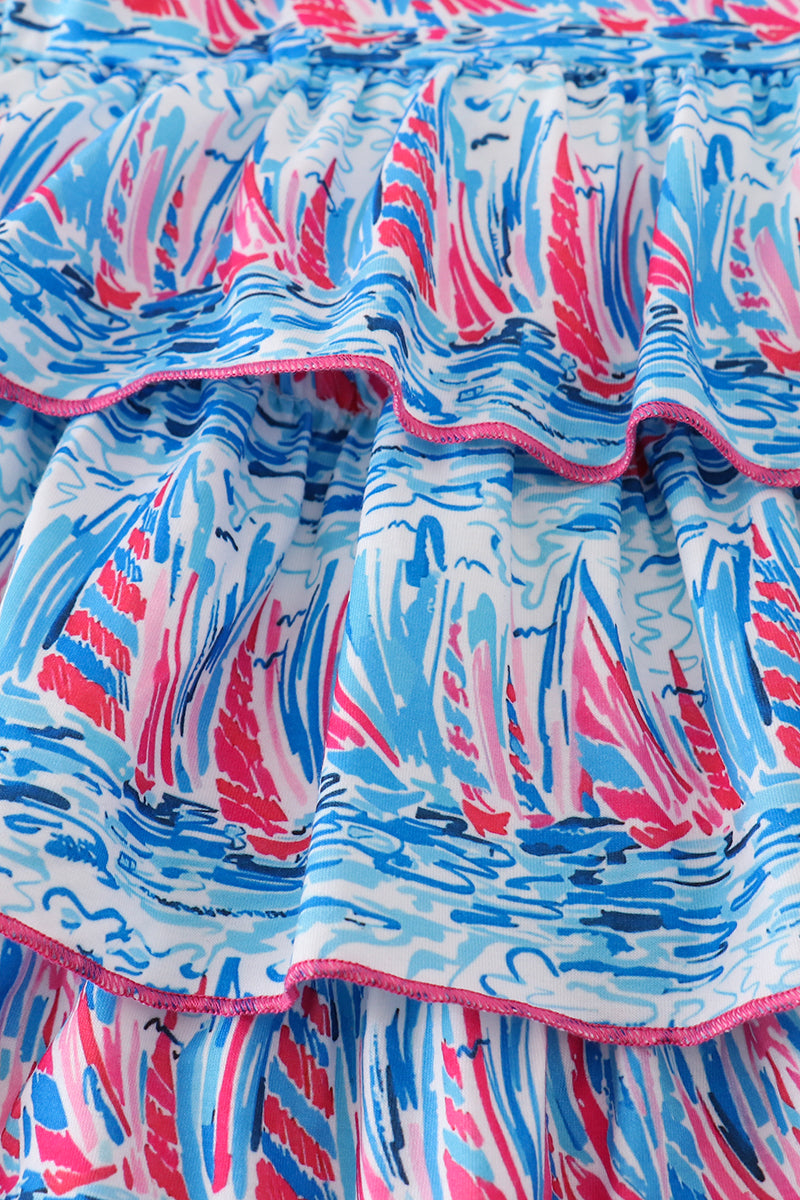 Matching mom and me dresses with playful blue sailboat print, perfect for summer outings.