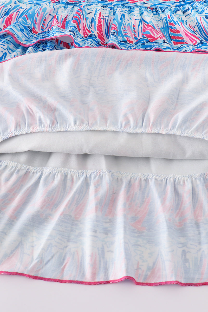 Matching mom and me dresses with playful blue sailboat print, perfect for summer outings.