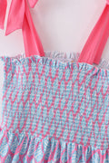 Matching blue smocked dresses with ribbon lace detailing for mom and daughter.