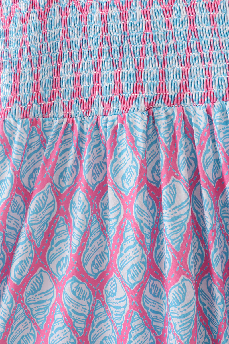 Matching blue smocked dresses with ribbon lace detailing for mom and daughter.