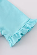 Mint green girl’s top with a whimsical bow print, perfect for playful days.