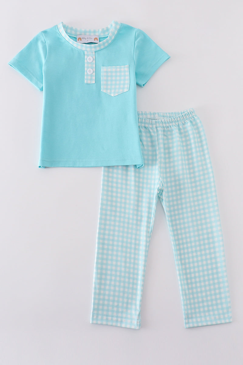 Blue aqua meadow boy set: playful floral pattern, short-sleeve shirt, and matching shorts.