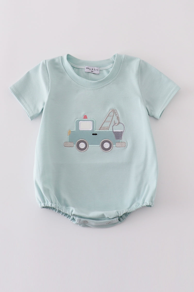 Blue crane truck applique bubble romper with playful truck design on the front.