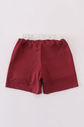 Maroon swim trunks with playful elephant embroidery, perfect for beach fun.