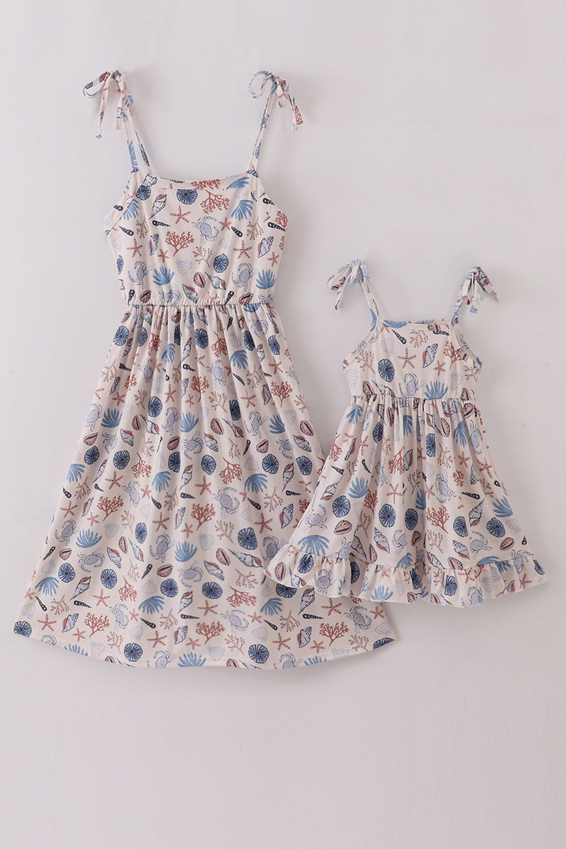 Matching Blue Ocean Breeze dress with shell print, perfect for mom and daughter.