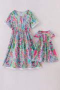A vibrant Rainbow Garden print mom-and-me dress with playful floral patterns.