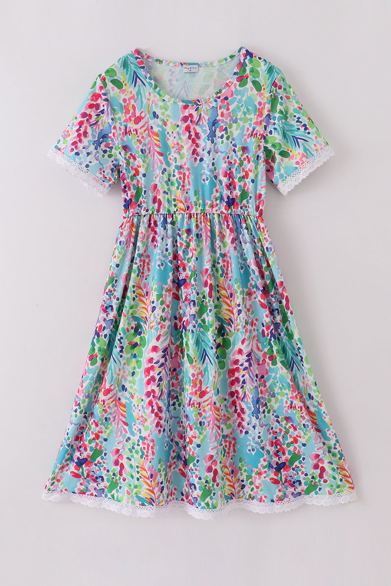 A vibrant Rainbow Garden print mom-and-me dress with playful floral patterns.