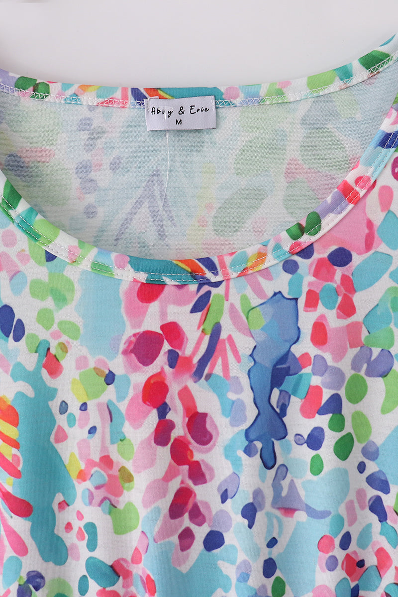 A vibrant Rainbow Garden print mom-and-me dress with playful floral patterns.