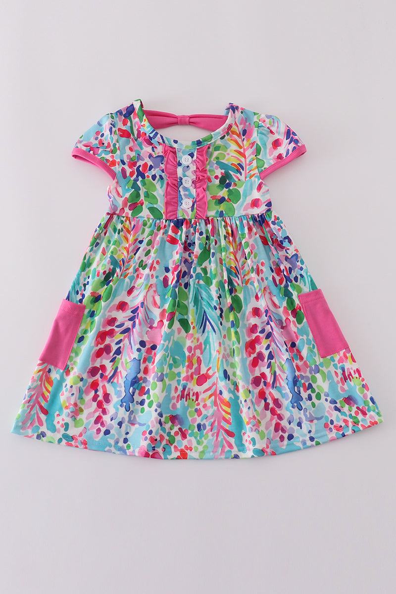 A vibrant Rainbow Garden print mom-and-me dress with playful floral patterns.