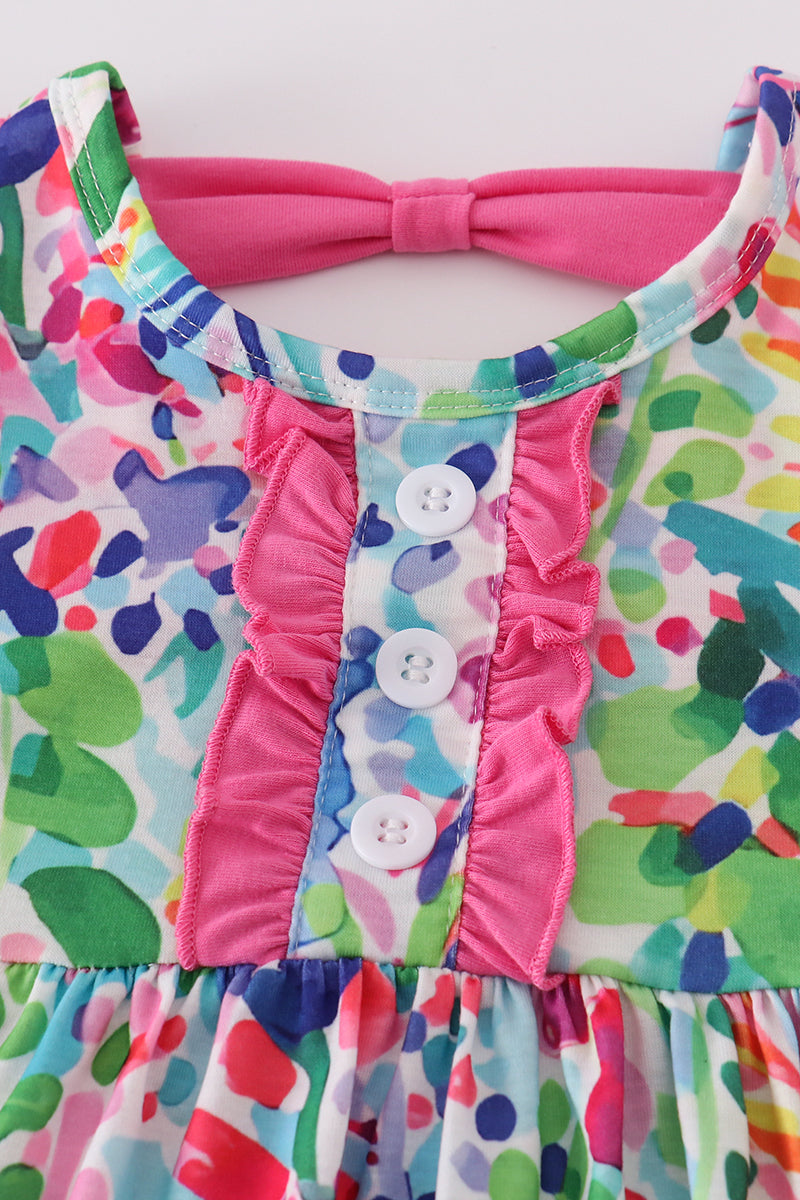 A vibrant Rainbow Garden print mom-and-me dress with playful floral patterns.