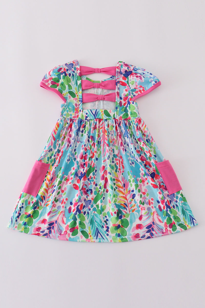 A vibrant Rainbow Garden print mom-and-me dress with playful floral patterns.