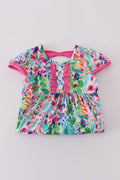 A vibrant Rainbow Garden print mom-and-me dress with playful floral patterns.