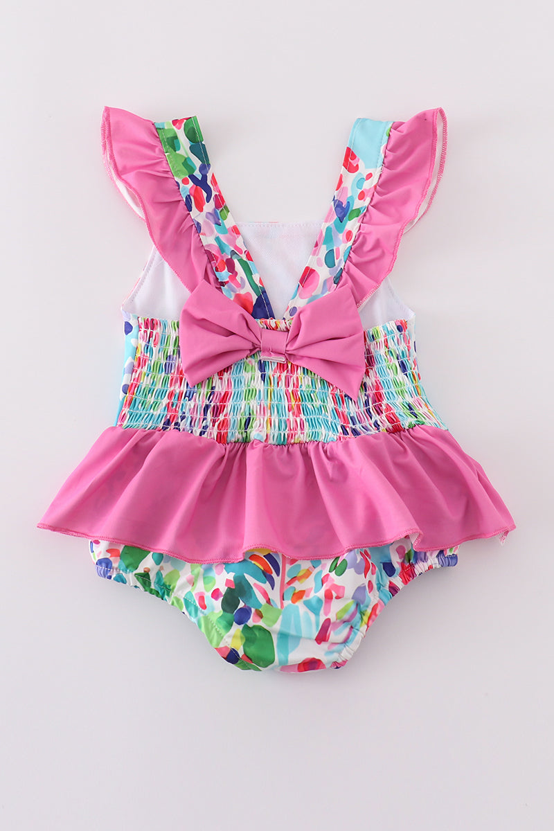 Colorful one-piece swimsuit with a vibrant rainbow garden print, perfect for summer fun.