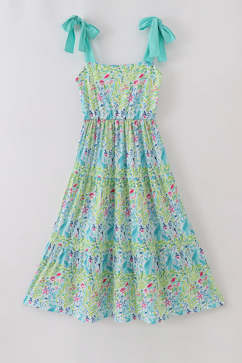 A vibrant, tiered mom dress with ocean bloom print, perfect for summer outings.