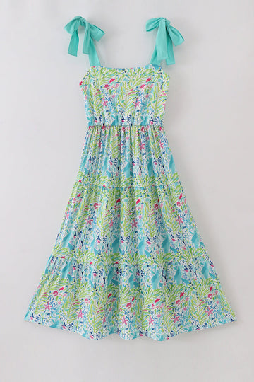 A vibrant, tiered mom dress with ocean bloom print, perfect for summer outings.
