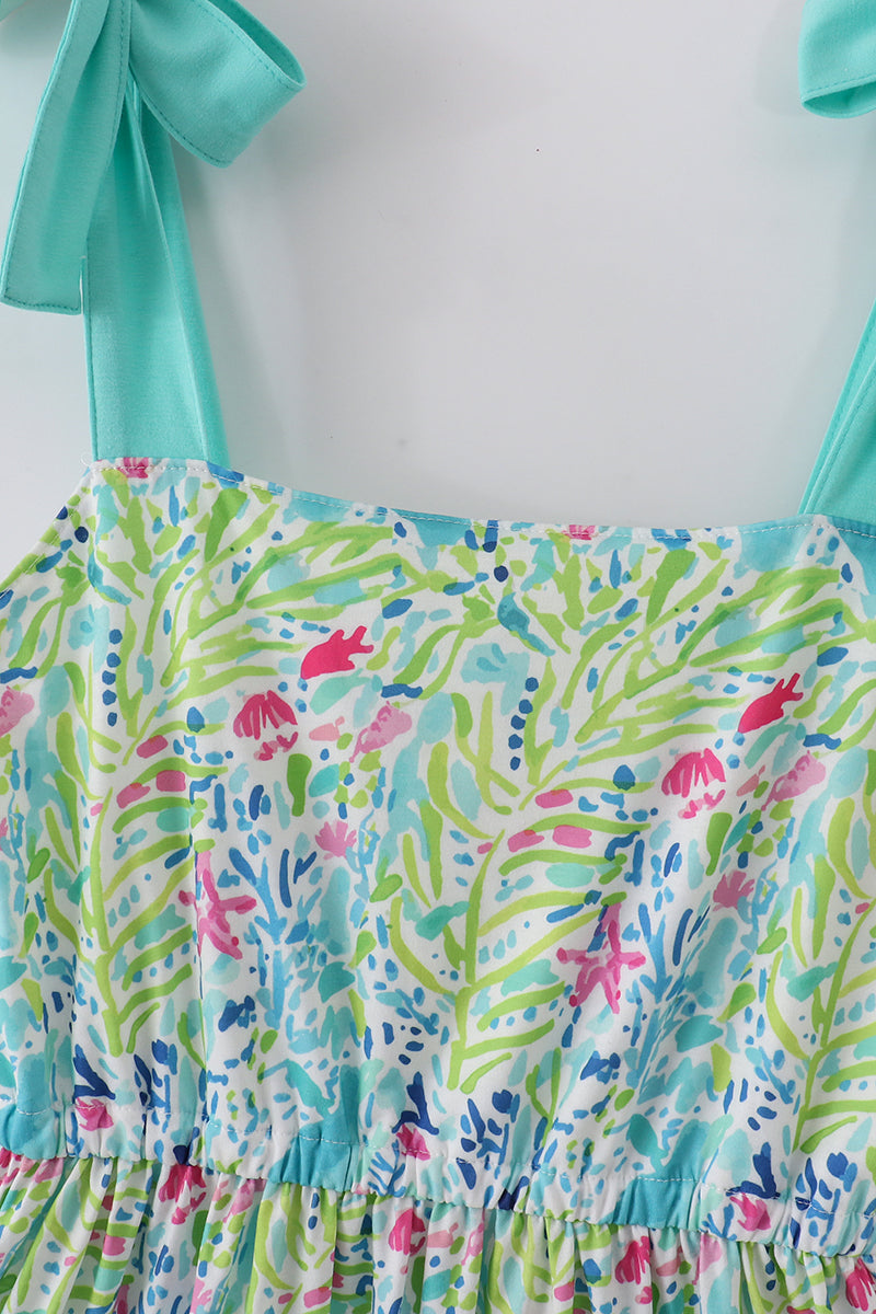 A vibrant, tiered mom dress with ocean bloom print, perfect for summer outings.