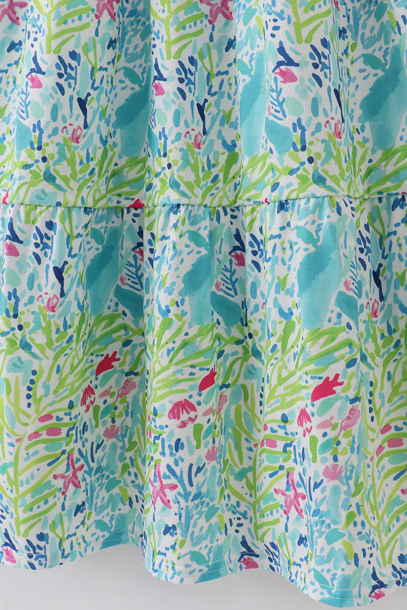 A vibrant, tiered mom dress with ocean bloom print, perfect for summer outings.