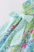 Ocean bloom print ruffle dress with vibrant ocean-themed patterns and playful ruffles.