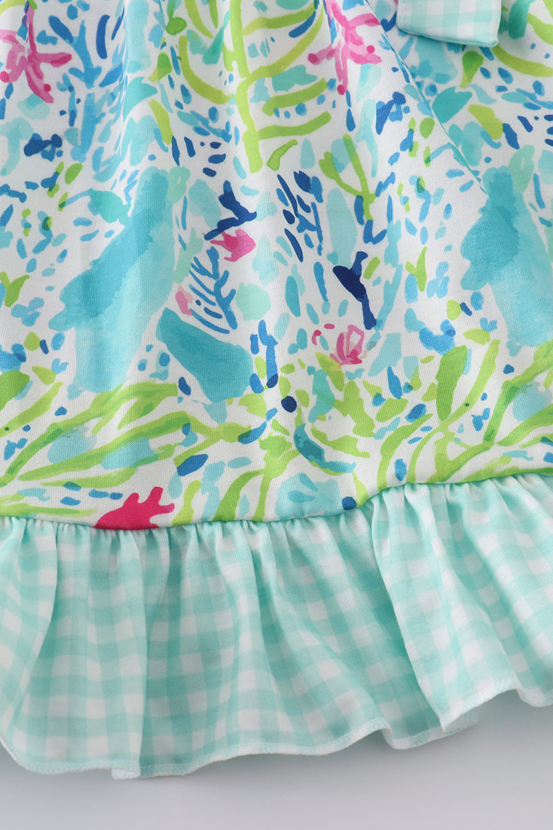 Ocean bloom print ruffle dress with vibrant ocean-themed patterns and playful ruffles.