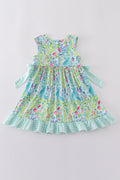 Ocean bloom print ruffle dress with vibrant ocean-themed patterns and playful ruffles.