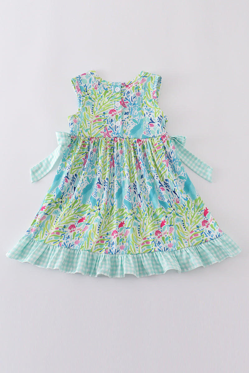 Ocean bloom print ruffle dress with vibrant ocean-themed patterns and playful ruffles.
